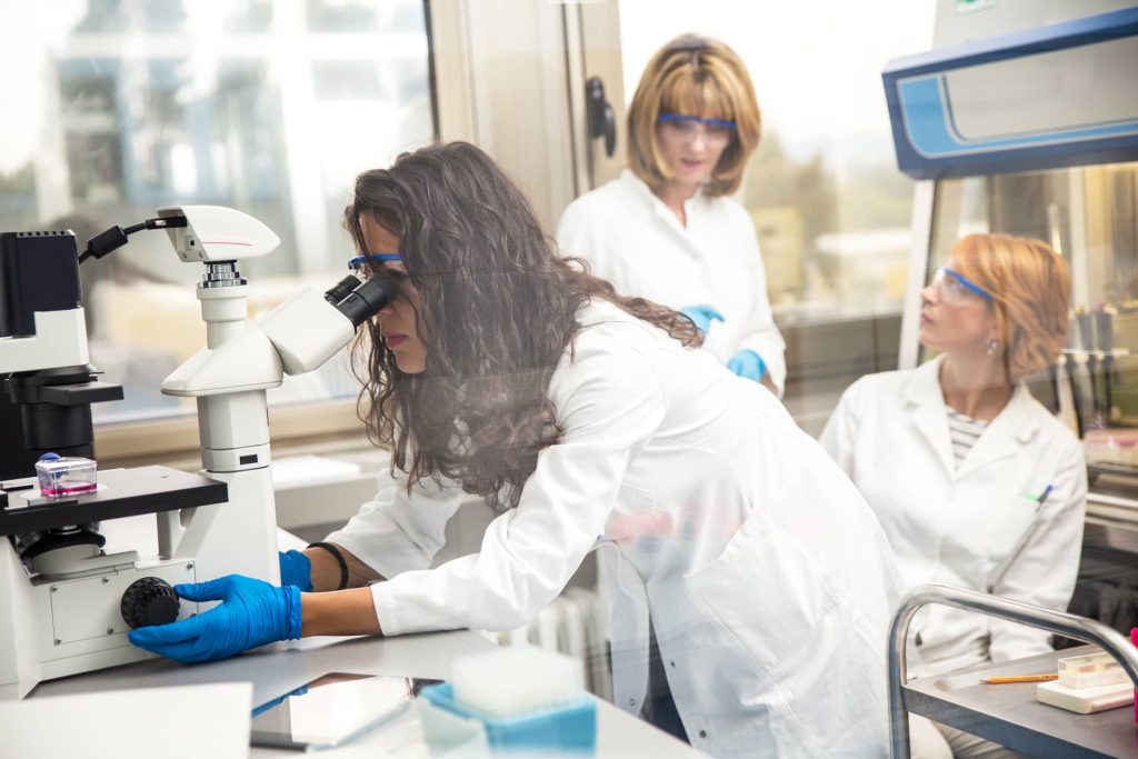 photo-of-real-female-scientist-looking-into-a-micr-2023-11-27-04-55-39-utc